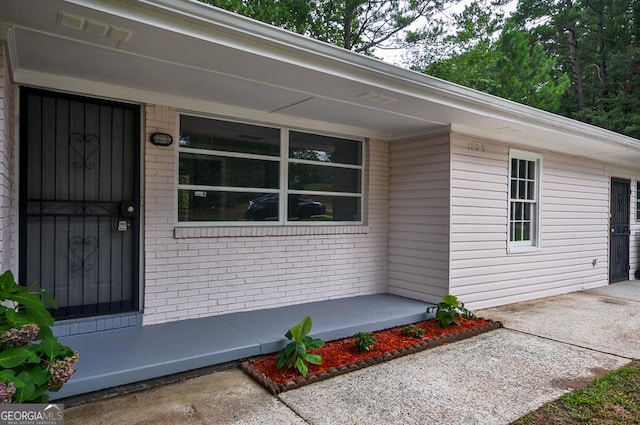 entrance to property with brick siding