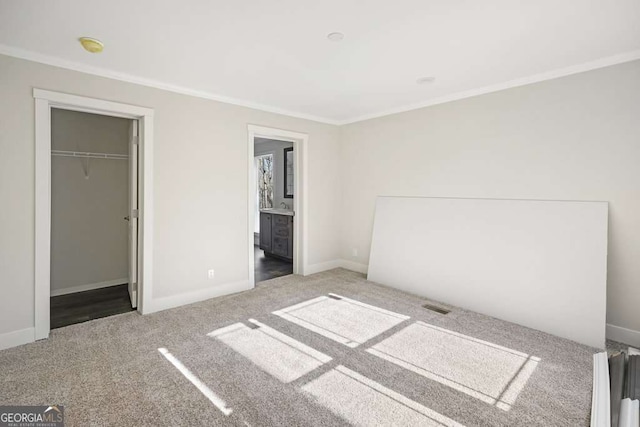 626 Candy Ln, Ellijay, GA 30540 - unfurnished bedroom with crown molding, carpet flooring, a walk in closet, and a closet
