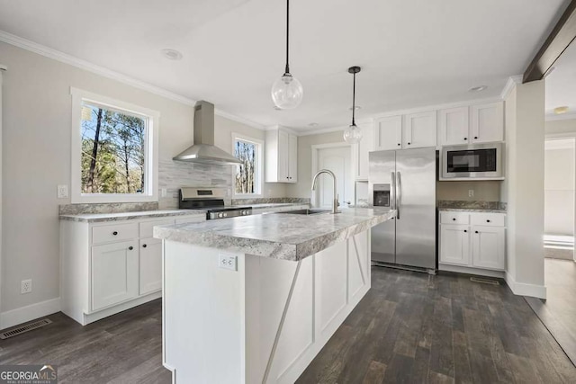 626 Candy Ln, Ellijay, GA 30540 - kitchen featuring stainless steel appliances, wall chimney exhaust hood, healthy amount of natural light, light countertops, and crown molding