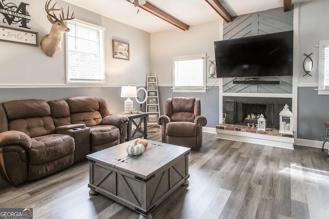 321 N Grove Blvd, Kingsland, GA 31548 - living area featuring beamed ceiling, plenty of natural light, wood finished floors, and a fireplace with raised hearth