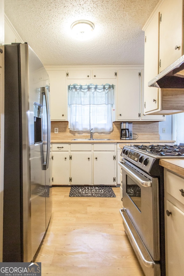 321 N Grove Blvd, Kingsland, GA 31548 - kitchen with appliances with stainless steel finishes, a textured ceiling, light wood finished floors, and light countertops