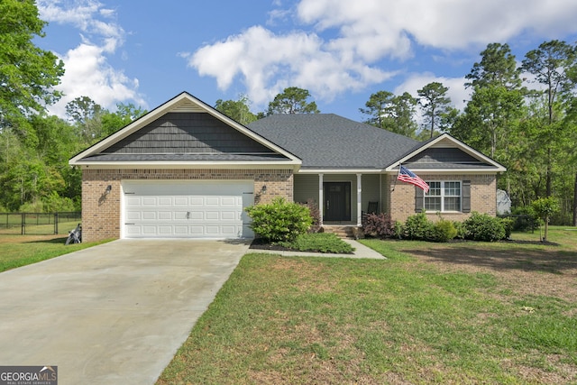 view of front of home featuring brick siding, fence, a front lawn, and concrete driveway