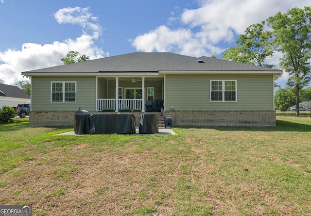 rear view of house with a lawn and ceiling fan