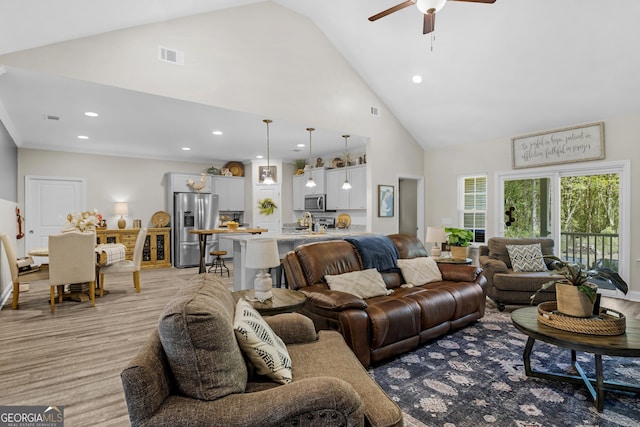 living area featuring recessed lighting, high vaulted ceiling, ceiling fan, and visible vents
