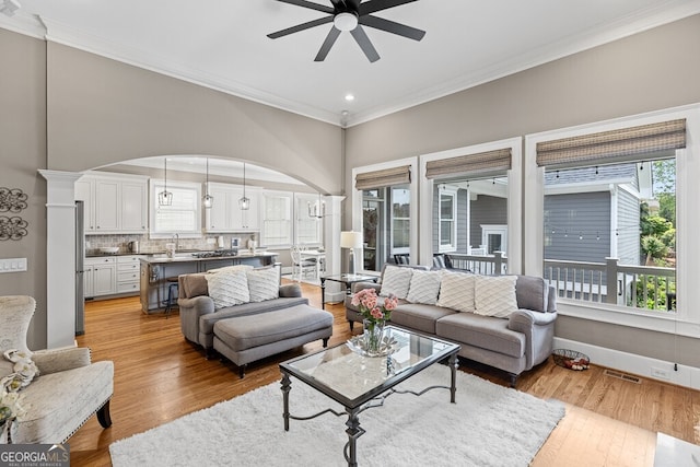 5841 Choctaw Ln, Braselton, GA 30517 - living area featuring visible vents, ceiling fan, arched walkways, ornamental molding, and a wealth of natural light