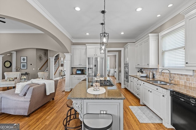 5841 Choctaw Ln, Braselton, GA 30517 - kitchen with arched walkways, open floor plan, appliances with stainless steel finishes, and a sink