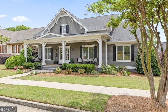 5841 Choctaw Ln, Braselton, GA 30517 - view of front facade with a front lawn, covered porch, and roof with shingles