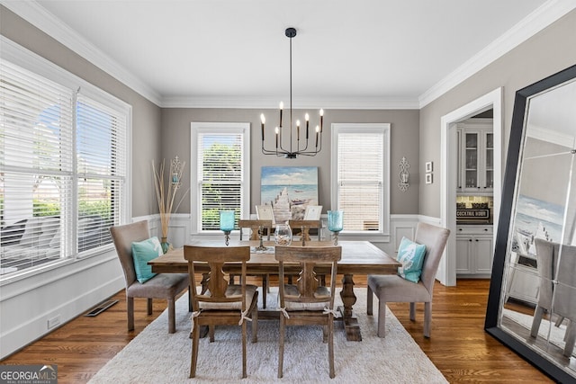 5841 Choctaw Ln, Braselton, GA 30517 - dining area featuring crown molding, visible vents, dark wood-style floors, a notable chandelier, and wainscoting