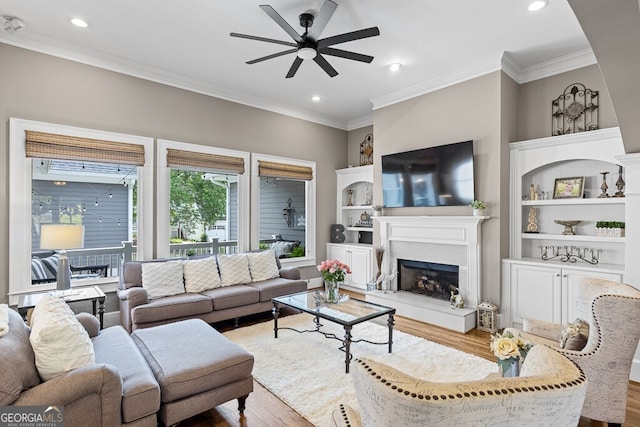 5841 Choctaw Ln, Braselton, GA 30517 - living room with a ceiling fan, wood finished floors, a high end fireplace, and crown molding