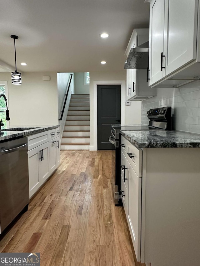 kitchen featuring white cabinetry, recessed lighting, stainless steel appliances, and light wood-style flooring