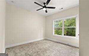 empty room featuring baseboards and ceiling fan