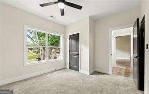 unfurnished bedroom with carpet flooring, ceiling fan, and baseboards