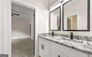 bathroom with a sink and double vanity