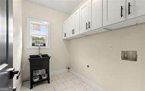 washroom with baseboards and cabinet space