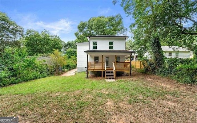 back of property featuring stairway and a yard