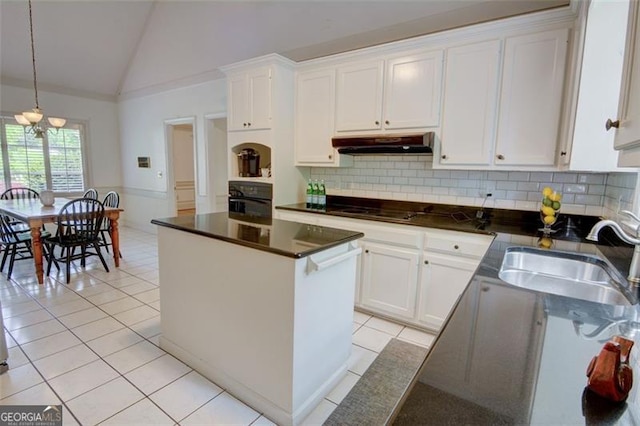5208 Fox Hill Ct, Peachtree Corners, GA 30092 - kitchen featuring under cabinet range hood, black appliances, light tile patterned floors, white cabinetry, and vaulted ceiling