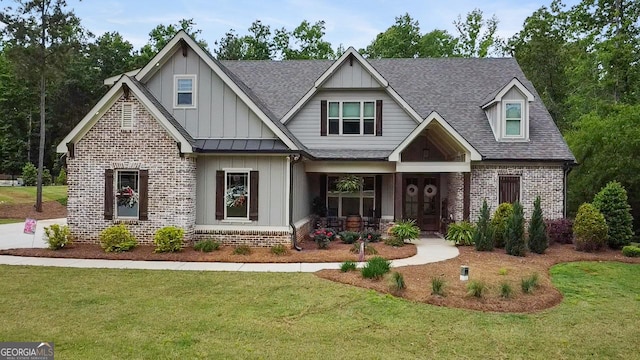 461 Preakness Way, Forsyth, GA 31029 - craftsman inspired home featuring brick siding, board and batten siding, covered porch, a front yard, and a shingled roof