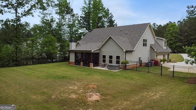 461 Preakness Way, Forsyth, GA 31029 - rear view of property with an attached garage, concrete driveway, a shingled roof, a sunroom, and a patio