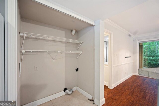 5400 Roswell Rd Unit L3, Sandy Springs, GA 30342 - laundry room with ornamental molding, electric dryer hookup, and wood finished floors