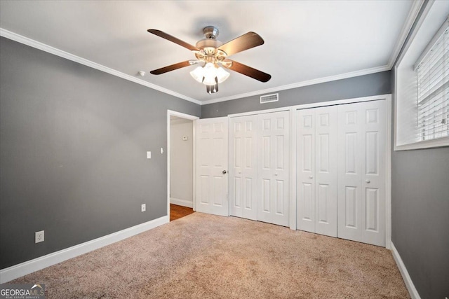 5400 Roswell Rd Unit L3, Sandy Springs, GA 30342 - unfurnished bedroom featuring two closets, carpet floors, ornamental molding, and a ceiling fan
