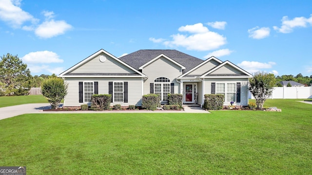craftsman-style home featuring a front lawn and fence