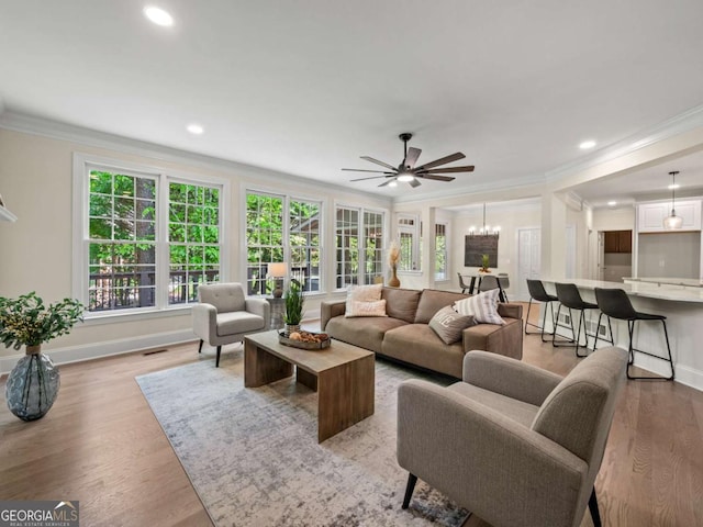 living room with crown molding, recessed lighting, ceiling fan, and a wealth of natural light