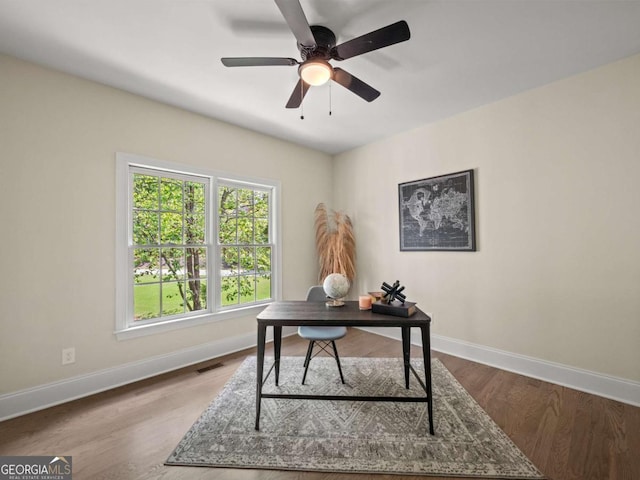 office area featuring baseboards, wood finished floors, and a ceiling fan