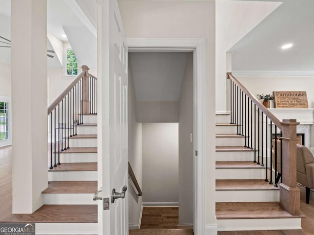 staircase with baseboards, recessed lighting, and wood finished floors