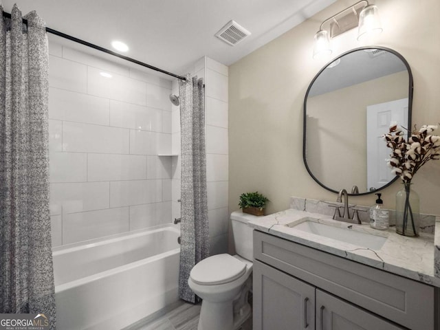 full bathroom featuring toilet, visible vents, shower / bathtub combination with curtain, and vanity