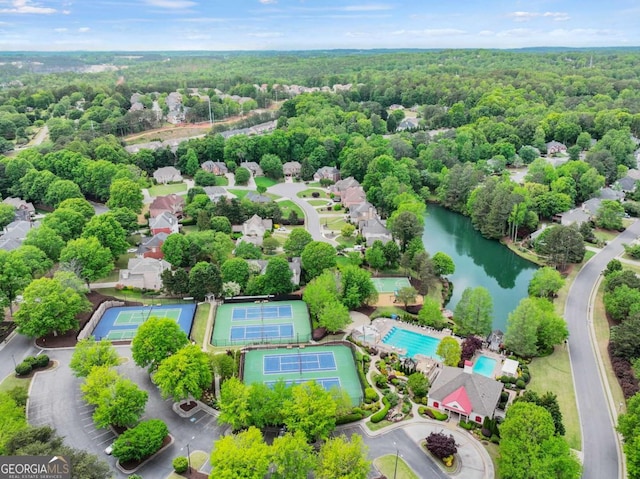 drone / aerial view featuring a water view and a forest view