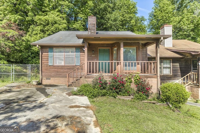 410 Steeplechase, Macon, GA 31204 - view of front of home with a chimney, a front yard, crawl space, fence, and a porch