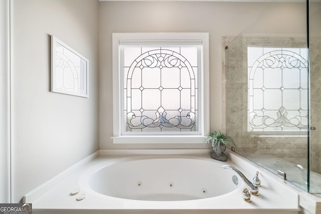 bathroom featuring a tub with jets