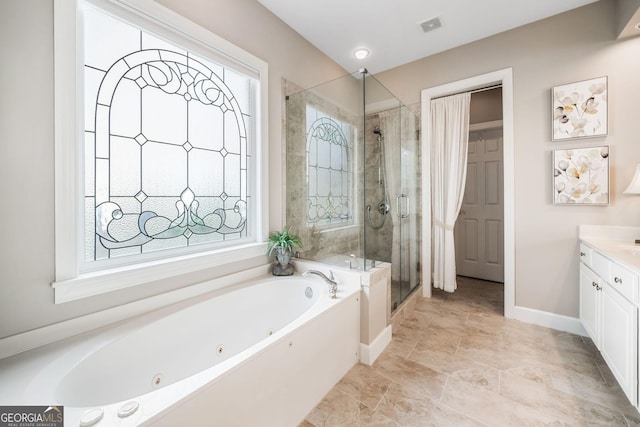full bathroom with visible vents, a wealth of natural light, a jetted tub, and a stall shower
