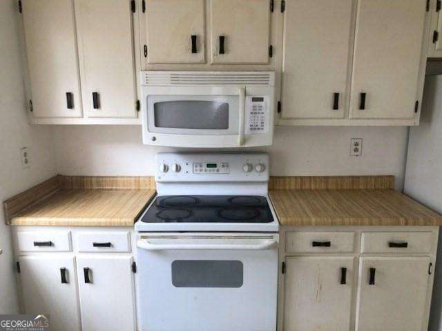 2617 Terrace Pkwy, Morrow, GA 30260 - kitchen with white cabinetry, white appliances, and light countertops