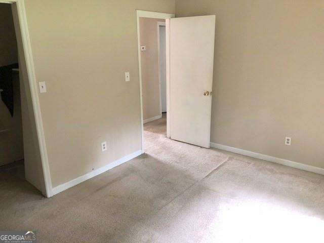 2617 Terrace Pkwy, Morrow, GA 30260 - unfurnished bedroom featuring baseboards and light carpet