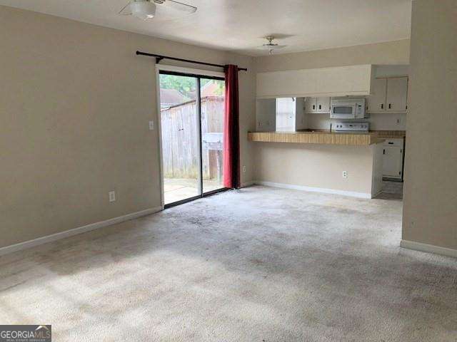 2617 Terrace Pkwy, Morrow, GA 30260 - unfurnished living room with ceiling fan, light colored carpet, and baseboards