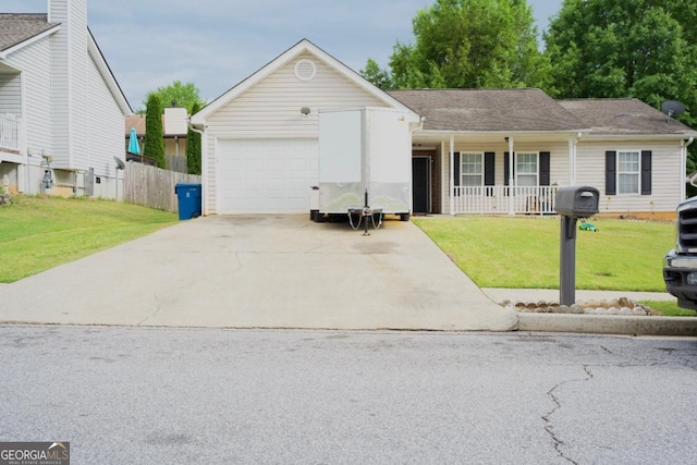 ranch-style house with fence, a front yard, concrete driveway, an attached garage, and a porch