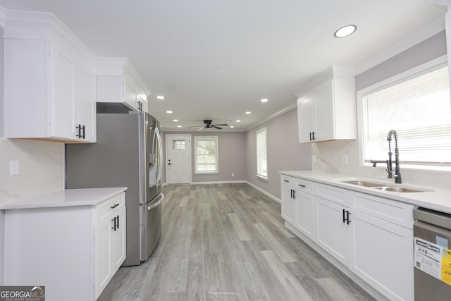 938 Motley St, Lagrange, GA 30241 - kitchen with a sink, stainless steel appliances, ceiling fan, white cabinetry, and light countertops