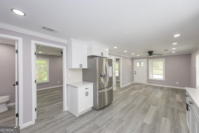 938 Motley St, Lagrange, GA 30241 - kitchen with crown molding, a ceiling fan, visible vents, baseboards, and stainless steel fridge with ice dispenser