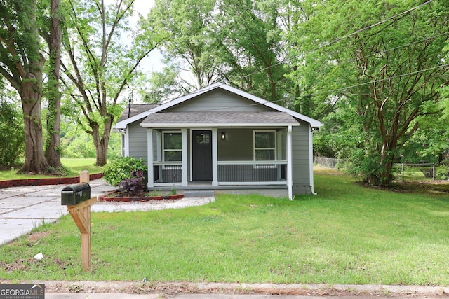 938 Motley St, Lagrange, GA 30241 - bungalow-style home featuring fence, roof with shingles, covered porch, and a front lawn