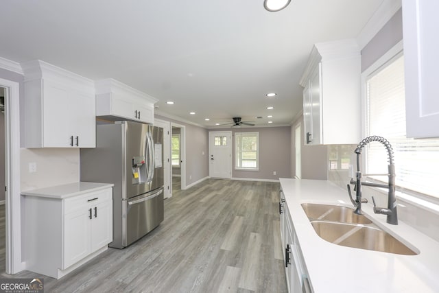 938 Motley St, Lagrange, GA 30241 - kitchen with white cabinets, stainless steel fridge, light countertops, and a sink