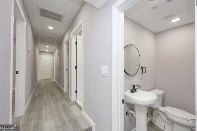938 Motley St, Lagrange, GA 30241 - bathroom featuring visible vents, wood finished floors, toilet, and a sink
