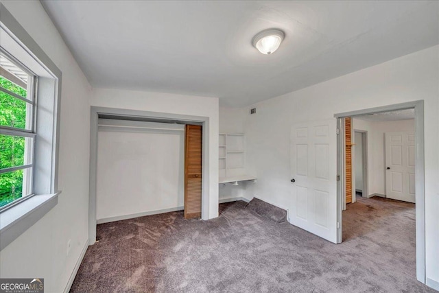 376 Mauldin Rd, Thomaston, GA 30286 - unfurnished bedroom with multiple windows, a closet, baseboards, and carpet floors