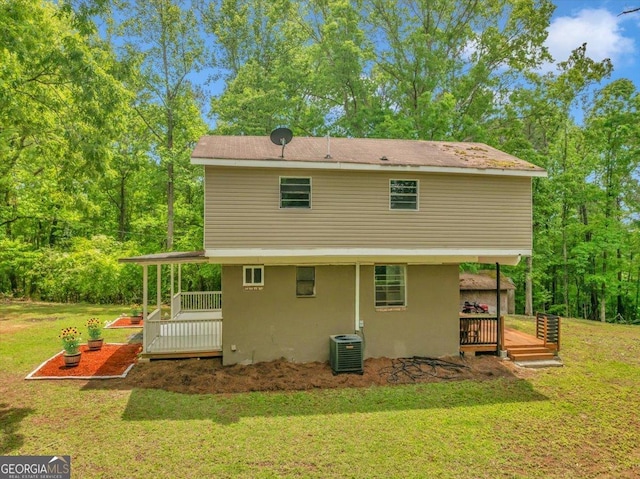 376 Mauldin Rd, Thomaston, GA 30286 - rear view of house featuring a lawn, a wooden deck, stucco siding, and central air condition unit
