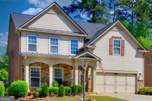 5845 Princeton Run Trl, Tucker, GA 30084 - view of front of home with a standing seam roof, a garage, stone siding, covered porch, and concrete driveway