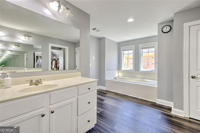 5845 Princeton Run Trl, Tucker, GA 30084 - bathroom with vanity, a garden tub, wood finished floors, a spacious closet, and recessed lighting