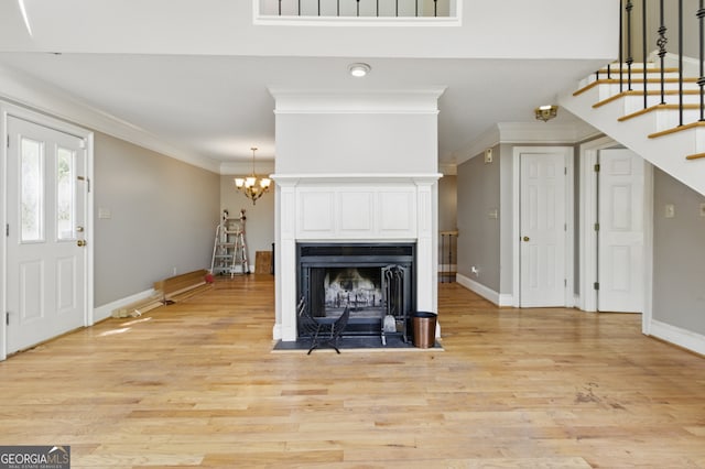 15635 US Highway 27 N, Hamilton, GA 31811 - living room featuring crown molding, stairs, baseboards, and light wood-style flooring