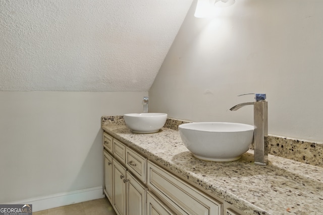 15635 US Highway 27 N, Hamilton, GA 31811 - full bathroom featuring double vanity, a sink, a textured ceiling, and tile patterned flooring