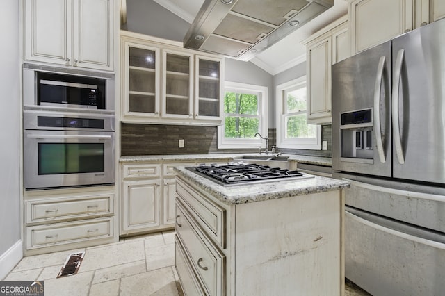 15635 US Highway 27 N, Hamilton, GA 31811 - kitchen with decorative backsplash, cream cabinetry, light stone counters, a sink, and appliances with stainless steel finishes