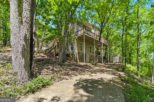 15635 US Highway 27 N, Hamilton, GA 31811 - view of property exterior with an outbuilding, a wooden deck, a shed, concrete driveway, and stairs